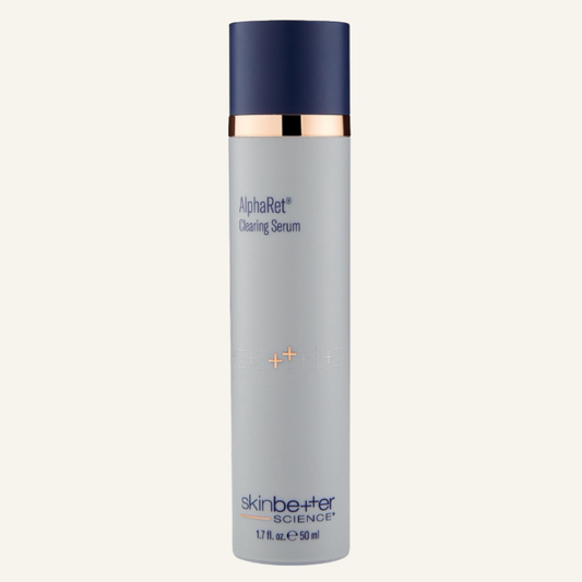 Skin Better Science AlphaRet Cleansing Serum in a tall 1.7oz cylindrical bottle with a light gray body, dark navy blue cap, and a metallic gold collar, shown on a light off-white background.