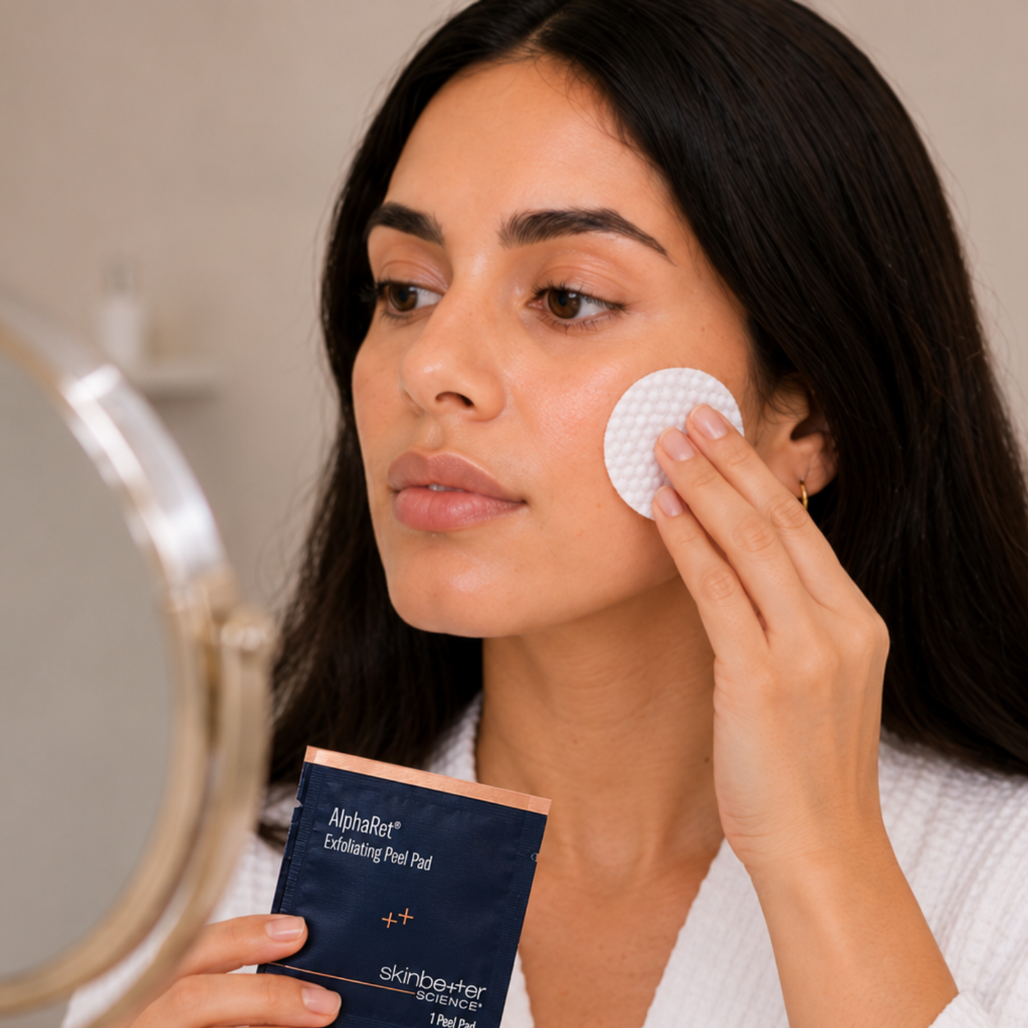 Applying skinbetter science AlphaRet Exfoliating Peel Pad for smoother, brighter skin