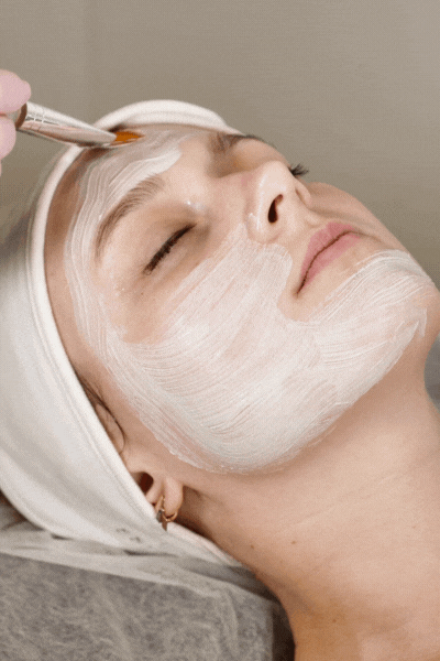 Cosmetologist Applying Facial Mask